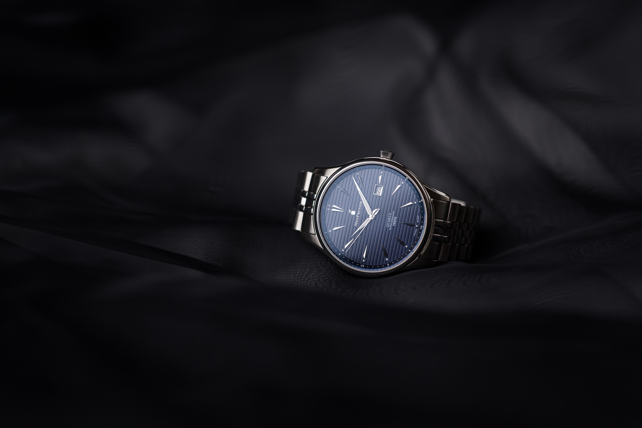 Deep Blue dial resting on dark fabric